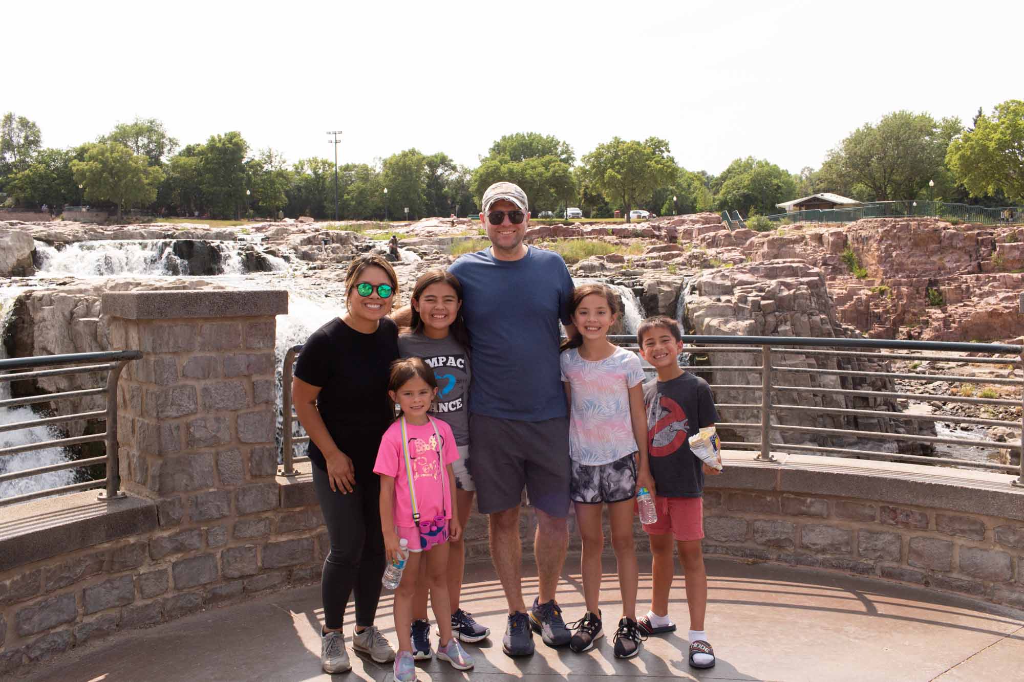 family posing in front of falls park in sioux falls picture waterfall